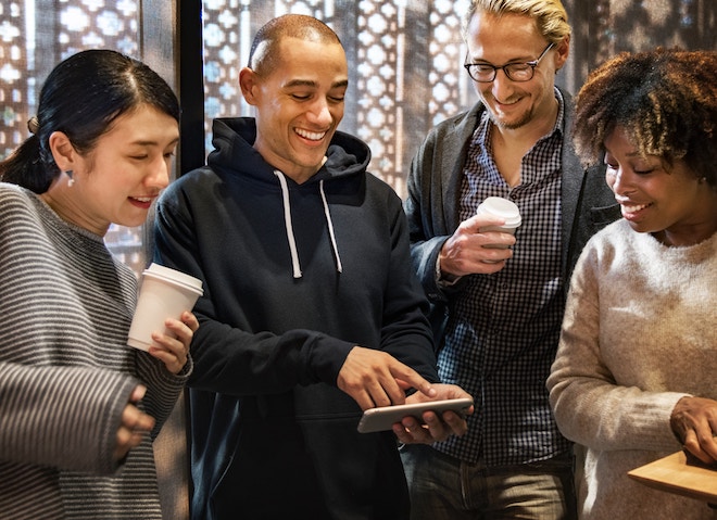 People all looking at phone and laughing