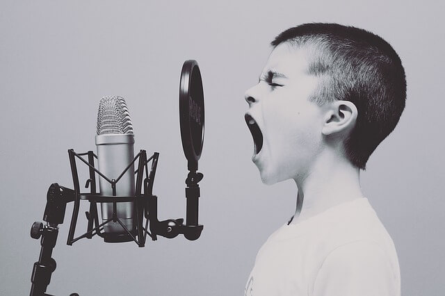 Boy yelling into microphone