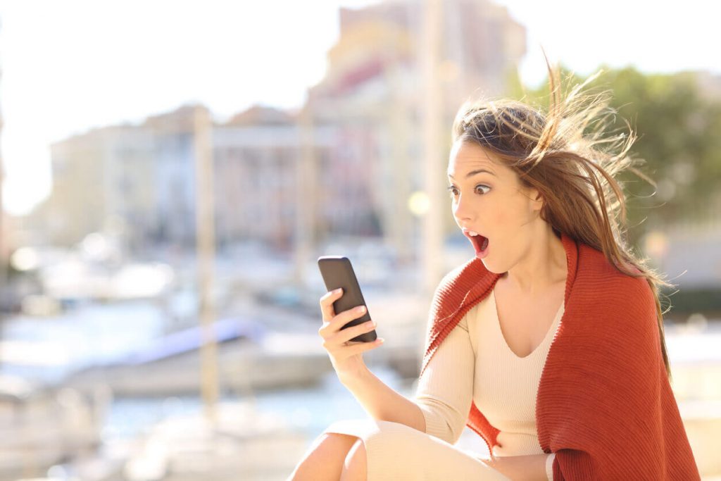 Amazed woman on phone